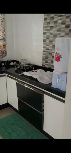 a kitchen with a stove and a counter top at HOSTEL DA LÚ in Votuporanga