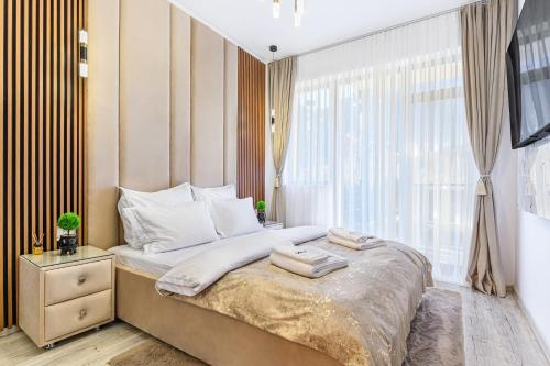 Tempat tidur dalam kamar di Ama Garden Apartment Busteni