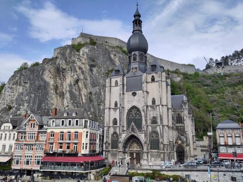 una grande chiesa con una montagna sullo sfondo di Le Patenier a Dinant