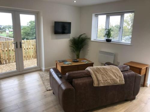 a living room with a couch and a table at Springwood farm 