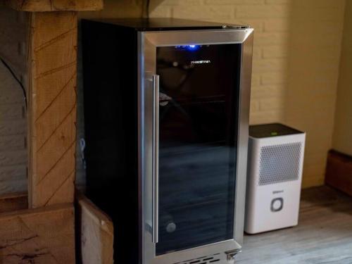 a black and silver refrigerator next to a speaker at Stonegate Lodge King Bed WIFI 50 Roku TV Salt Water Pool Room #104 in Eureka Springs