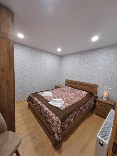 a bedroom with a bed with two plates on it at Kitesa's cozy apartment in Mtskheta