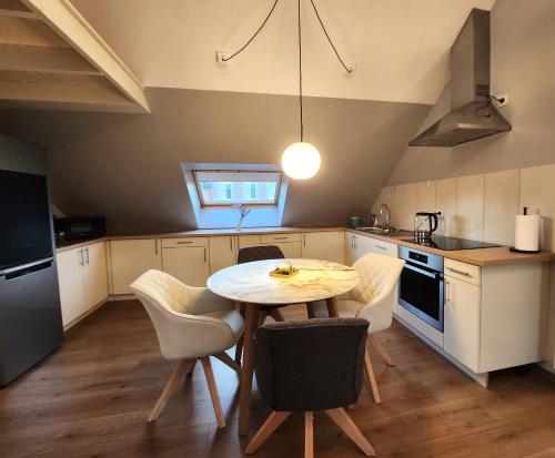 a kitchen with a table and chairs in a room at Appart4you in Namur