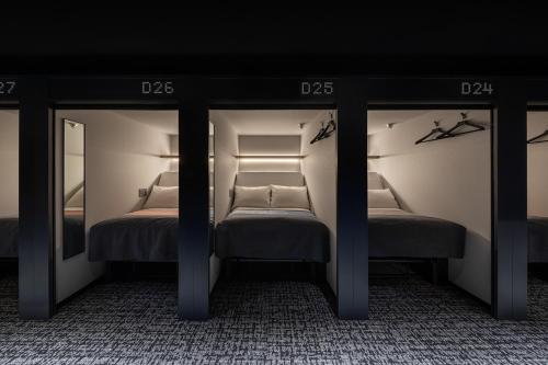 A bed or beds in a room at The Millennials Fukuoka