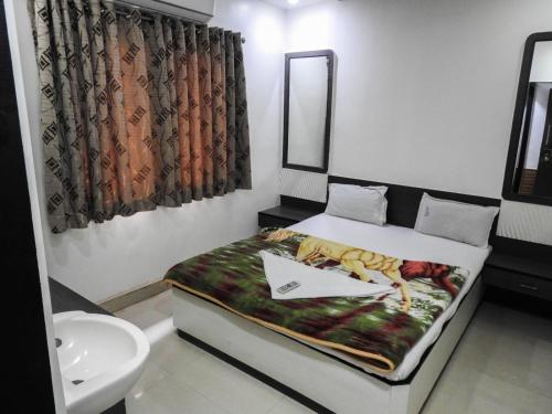 una piccola camera con letto e lavandino di Hotel Shree Sai Darshan a Shirdi