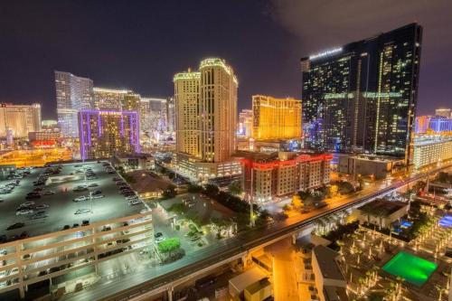 a view of a city at night with buildings at No Resort Fee Strip View Balcony+ Valet Parking in Las Vegas