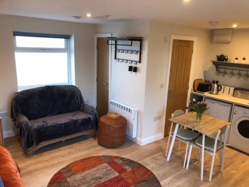 a living room with a couch and a table at The Studio in Harrogate