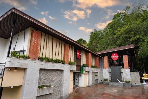 a building with two entrances to a parking lot at Vivera Highlands in Kodaikānāl