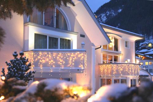 Um edifício com luzes de Natal à frente. em Grütter Luxury Apartments em Ischgl