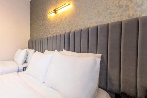 a bedroom with a bed with white pillows at Lenora Airport Hotel & İstanbul Airport in Arnavutköy