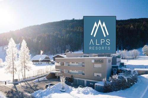 Ein Gebäude mit einem Schild im Schnee. in der Unterkunft Tauernresidence Radstadt by ALPS RESORTS in Radstadt