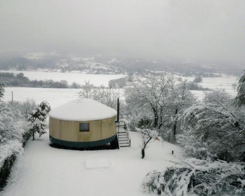 a yurt in the snow in a field at Kadosa Jurta Apartman in Esztergom