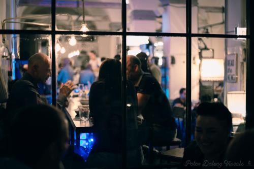 a group of people sitting at tables in a restaurant at Alter Schlachthof in Bressanone