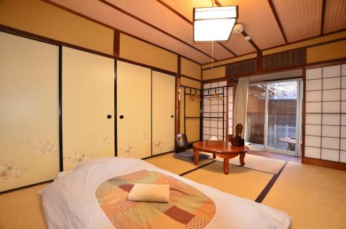 a bedroom with a bed and a desk in it at Colours in Kyoto