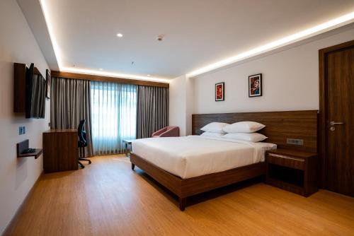 เตียงในห้องที่ Lilac Hotel Guruvayur