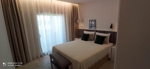 a hotel room with a bed and a window at Lagos Fly & Sea View Apartment in Lagos