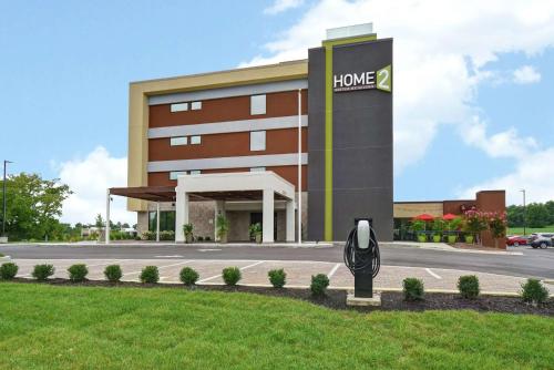 a hotel building with a clock in front of it at Home2 Suites By Hilton Frankfort in Frankfort