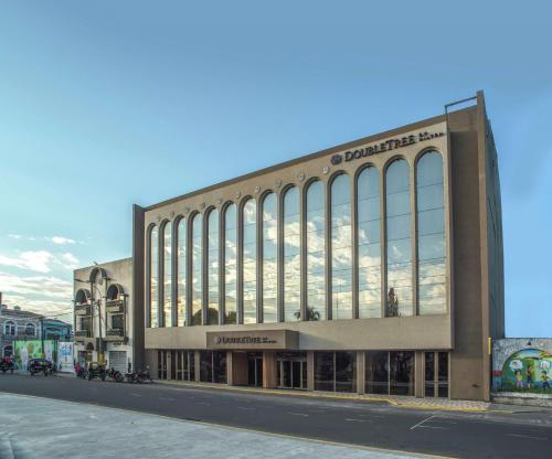 a large building with large windows on a street at Doubletree By Hilton Iquitos in Iquitos