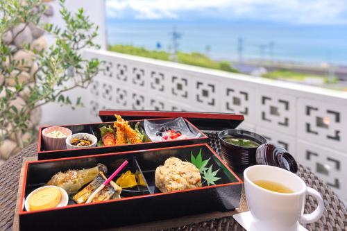 - une table avec 2 plateaux de nourriture et une tasse de café dans l'établissement Hotel Noir Blanc, à Shizuoka