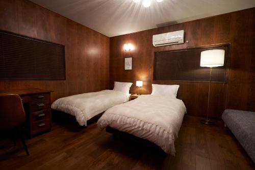 A bed or beds in a room at 結家 -MUSUBIYA-