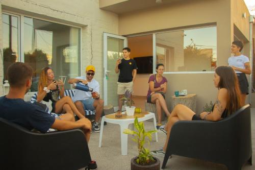 a group of people sitting in chairs in a room at Casa Amonite Hostel Boutique in Puerto Madryn