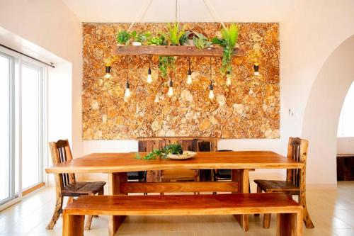 a dining room with a wooden table and chairs at Kumekucha Ocean View in Dar es Salaam