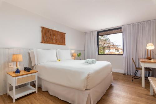 Una cama o camas en una habitación de Hotel Aretê