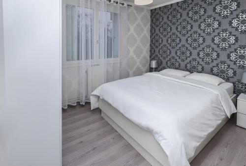 Cama ou camas em um quarto em Appartement moderne, proche du Parc de la tête d'Or et de Lyon