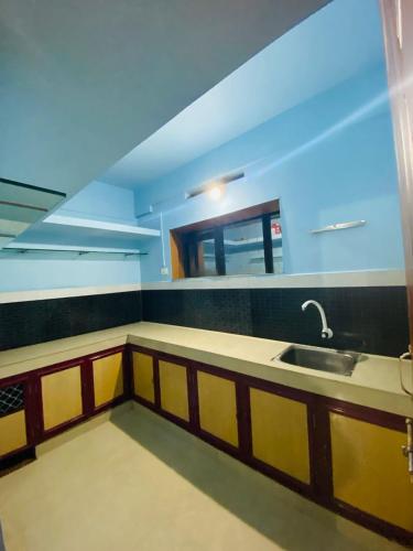 a kitchen with a sink and a counter top at VEE CEE TOWER FURNISHED APPARTMENT in Sultan Bathery