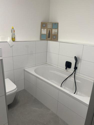 La salle de bains blanche est pourvue d'une baignoire et de toilettes. dans l'établissement Ferienwohnung Pfalzblick, à Bacharach