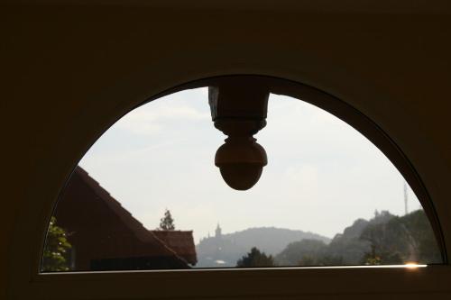 an arched window of a building with a light at family & friends in Wernigerode