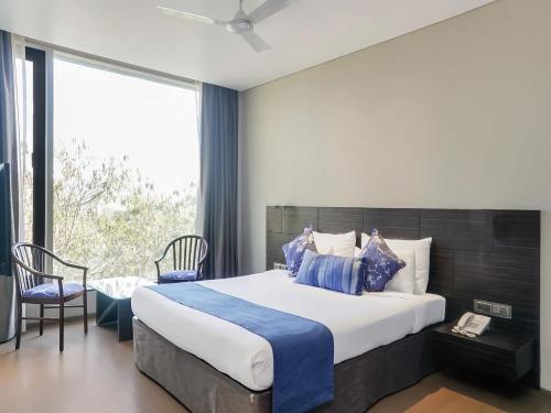 Un dormitorio con una cama grande y una ventana en Treebo Premium Niraali Executive, en Pune