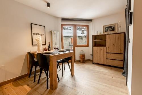 a dining room with a wooden table and chairs at HelloChalet - Friends Ski House in Breuil-Cervinia