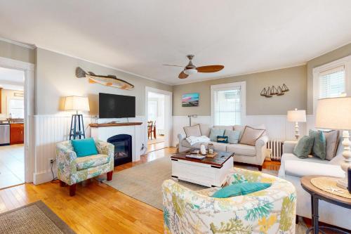 a living room with a couch and a fireplace at Gloucester Coastal Gem in Gloucester