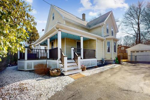 a yellow house with a porch and a driveway at Gloucester Coastal Gem in Gloucester