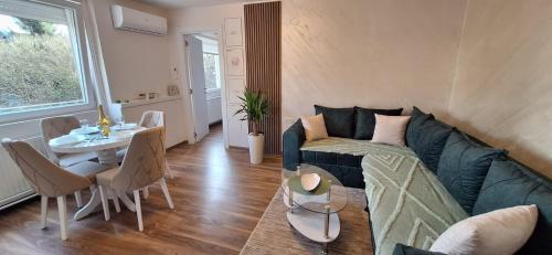 a living room with a couch and a table at Apartman Bonsai in Subotica