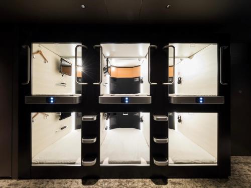 a room with three refrigerators in a room at Glansit Kyoto Kawaramachi in Kyoto