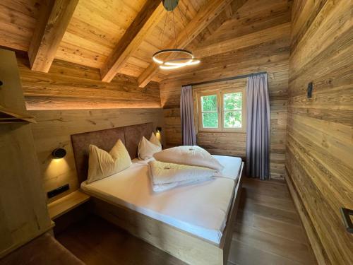 a bedroom in a log cabin with a bed at Hotel Zimmerbräu in St. Wolfgang