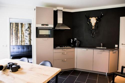 a kitchen with a table and a skull on the wall at COSY Holiday Home in Harderwijk