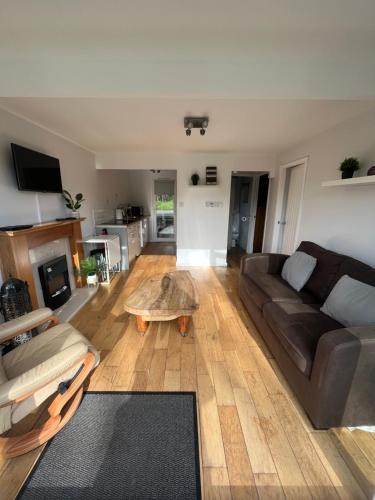 ein Wohnzimmer mit einem Sofa und einem Couchtisch in der Unterkunft North Wales Lake View 2 Bedroom in Caernarfon