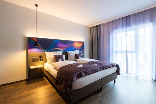 Кровать или кровати в номере Holiday Inn-the niu, Wave Karlsruhe Oststadt, an IHG Hotel