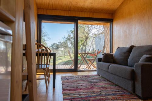 a living room with a couch and a table at Refugio do Carrascal in Tomar