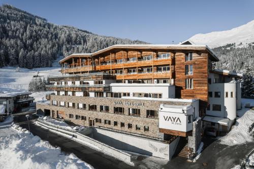 a building in the snow next to a mountain at VAYA St Zeno Serfaus in Serfaus