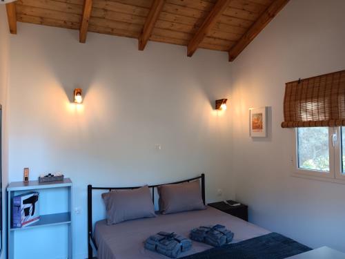 a bedroom with a bed with two pillows on it at Tolis Rooms in Himare