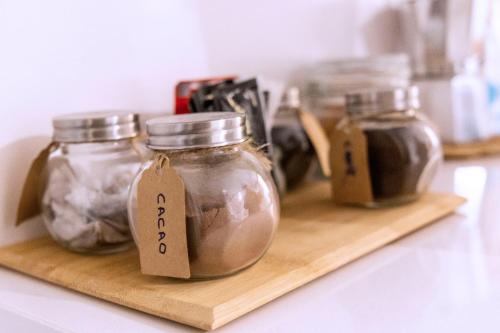 three jars of food on a wooden shelf at BELIA A.T. in Cáceres