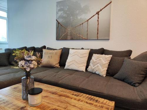 a brown couch in a living room with a bridge at * Wohlfühloase Köln I * in Cologne