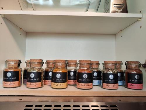 a shelf with jars of spices on it in a refrigerator at * Wohlfühloase Köln I * in Cologne