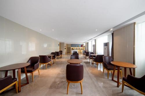 a row of tables and chairs in a waiting room at Guangzhou Baiyun Airport Yunzhi Hotel near Terminal One - Complimentary Shuttle Bus between hotel to Canton Fair Complex during Canton Fair in Guangzhou