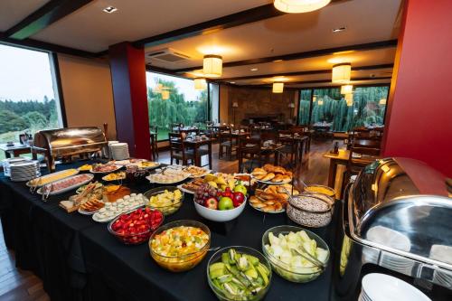 a buffet of food on a table in a restaurant at Loi Suites Chapelco Hotel in San Martín de los Andes