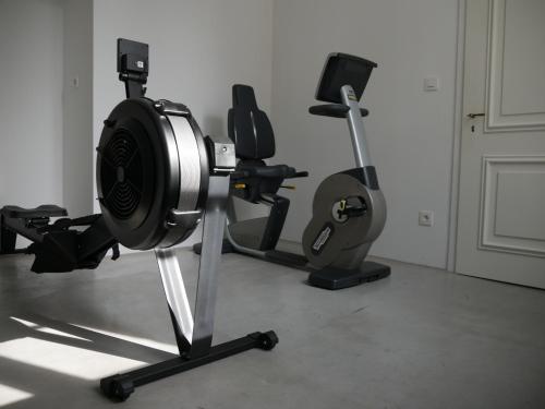 a room with a gym with two exercise machines at Château du Pont d'Oye in Habay-la-Neuve